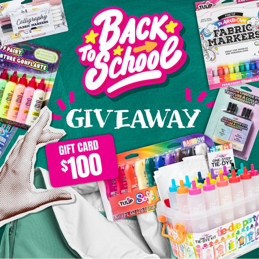 Back to School Giveaway promotion featuring Tulip fabric markers, tie-dye kits, and fabric paints displayed around a green chalkboard background. Large pink and white 'Back to School' text is centered, with 'Giveaway' written in chalk style below. A bright pink label highlights a $100 gift card prize.