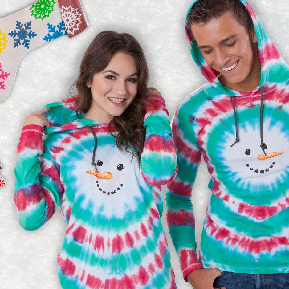Two people wearing tie-dye hoodies with snowman designs on a snowy background.