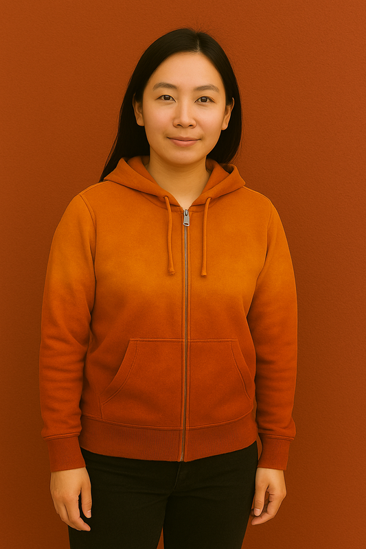 Person wearing a brown hoodie against a red-brown background