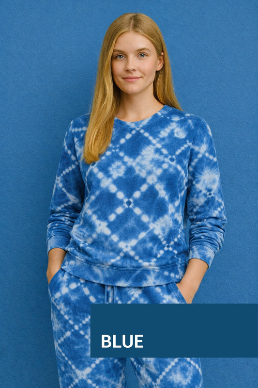 Woman wearing a blue tie-dye outfit against a blue background