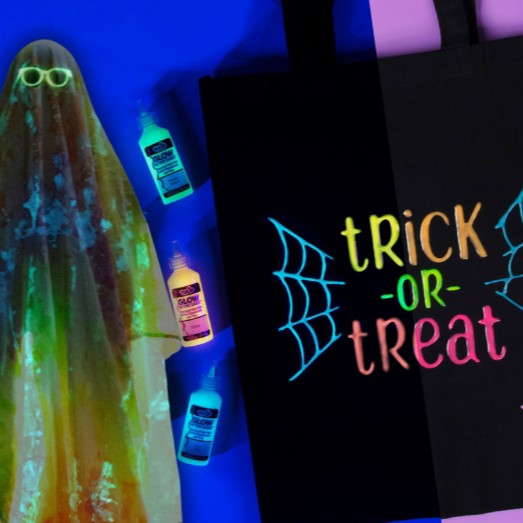 Black bag with 'trick or treat' text, glowing ghost, and bottles under UV light