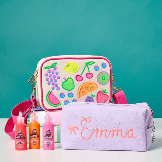 Colorful pouch with fruit designs and an embroidered name bag on a teal background